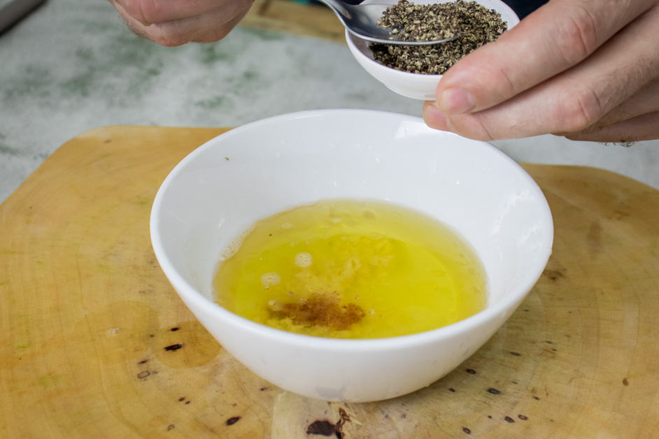 adding pepper to the quinoa tabbouleh