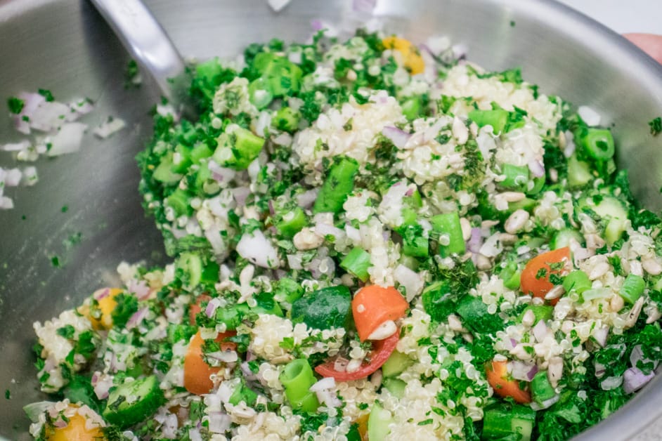 mixing the quinoa tabbouleh