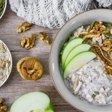 bircher-muesli-with-apple-figs-walnuts-and-pumpkin-seeds-in-a-bowl